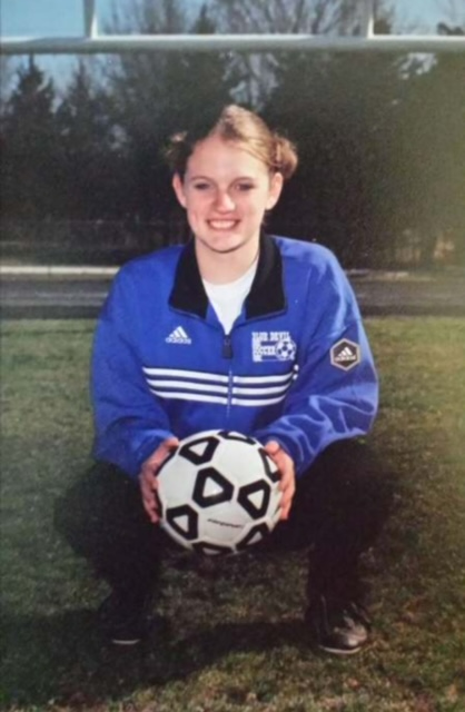 Kyleen holding a soccer ball.