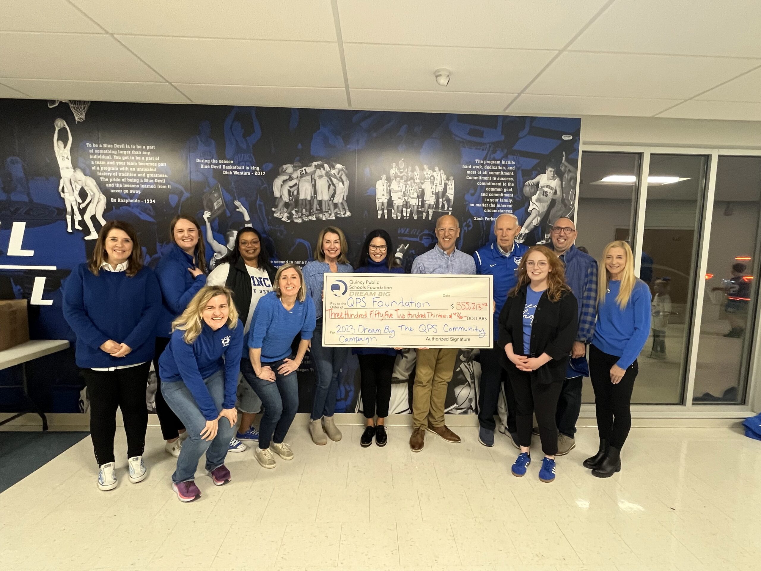 Campaign Chairs Tim & Wendy Koontz pose with QPSF staff and trustees after the campaign total announcement in February 2024.