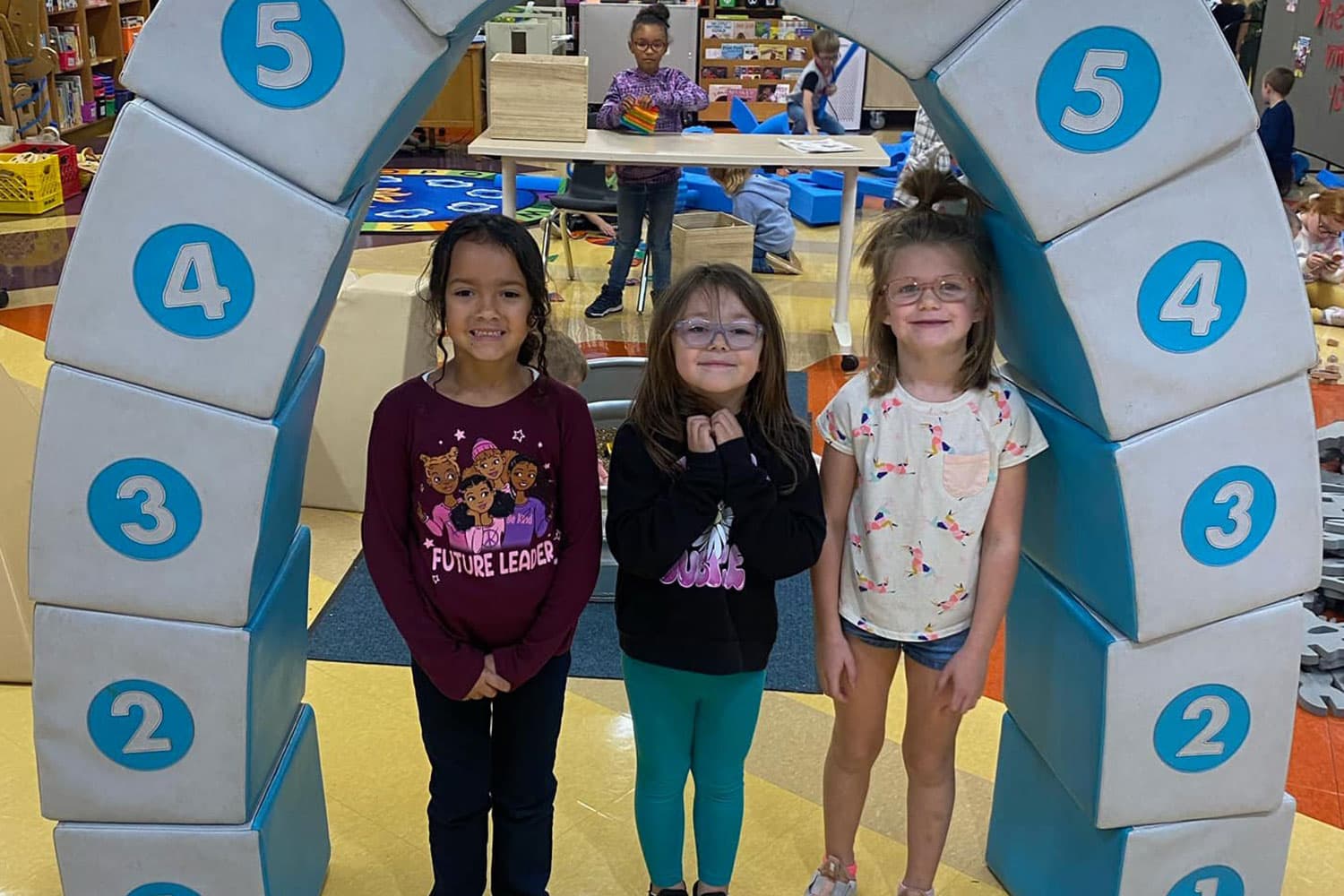 girls under arch of blocks provided by a grant