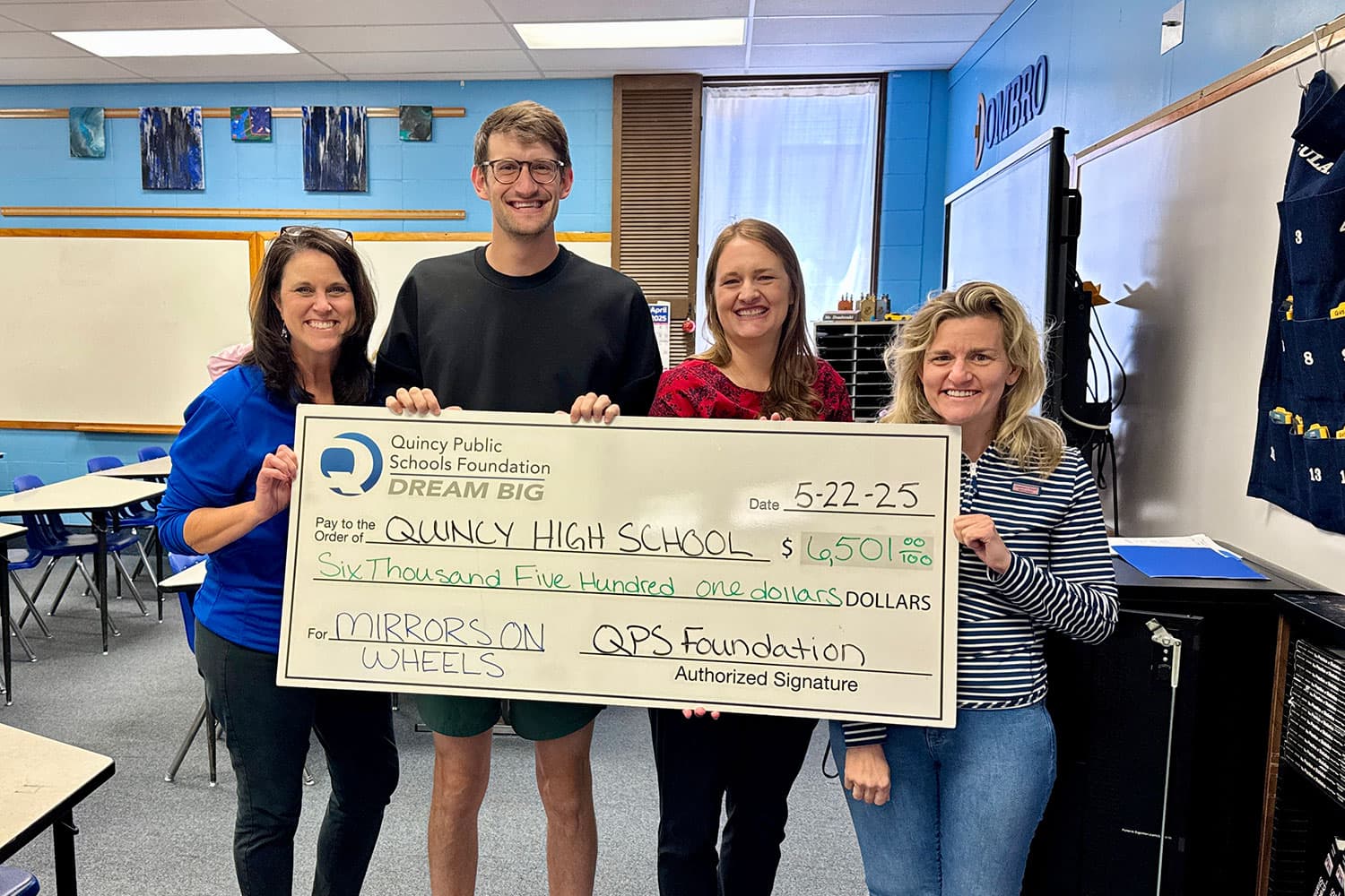 Grant award winner with check for Mirrors on Wheels